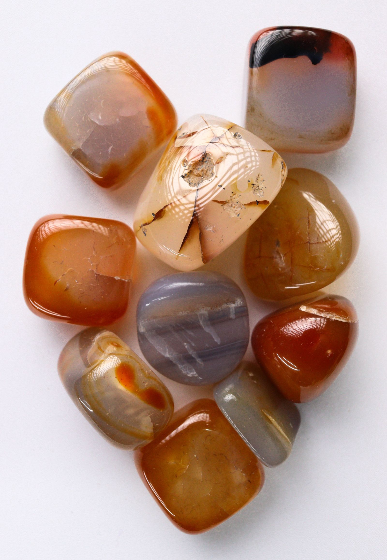 Polished agate stones in warm earthy tones, evoking Arizona fire agate