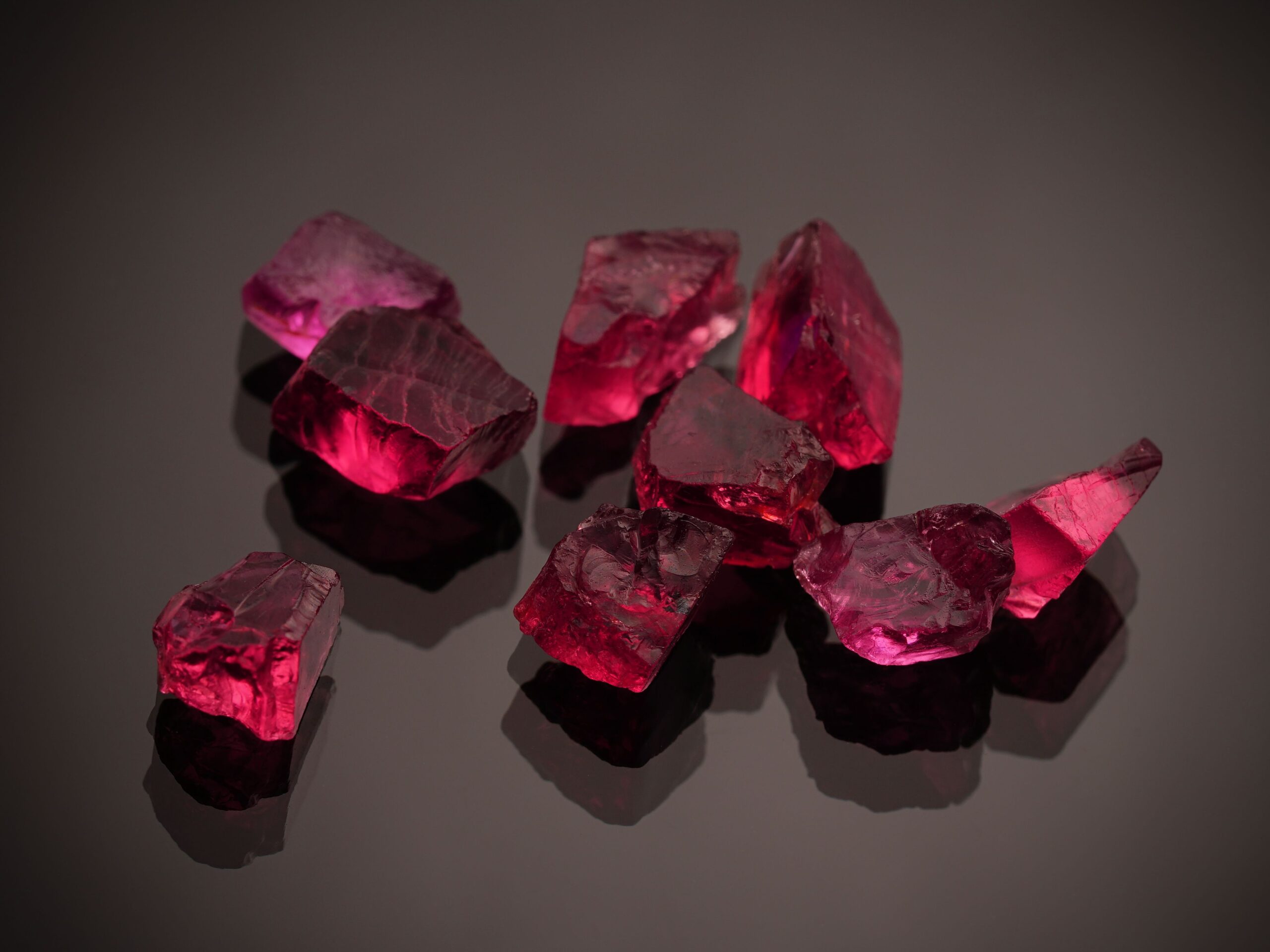 Deep red garnet gemstones on a dark surface