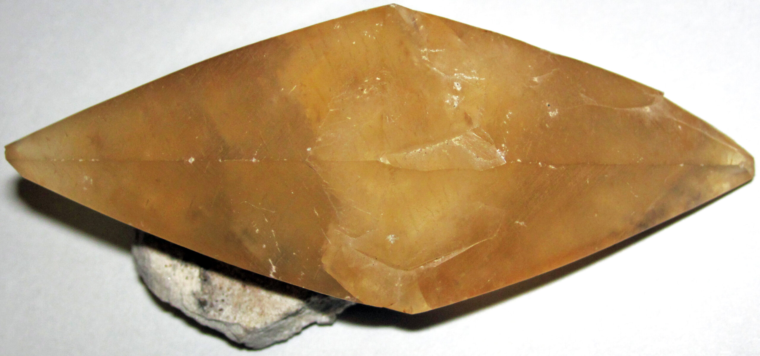 Colorless transparent rhombohedral calcite crystal, the carbonate mineral that fizzes readily in dilute acid