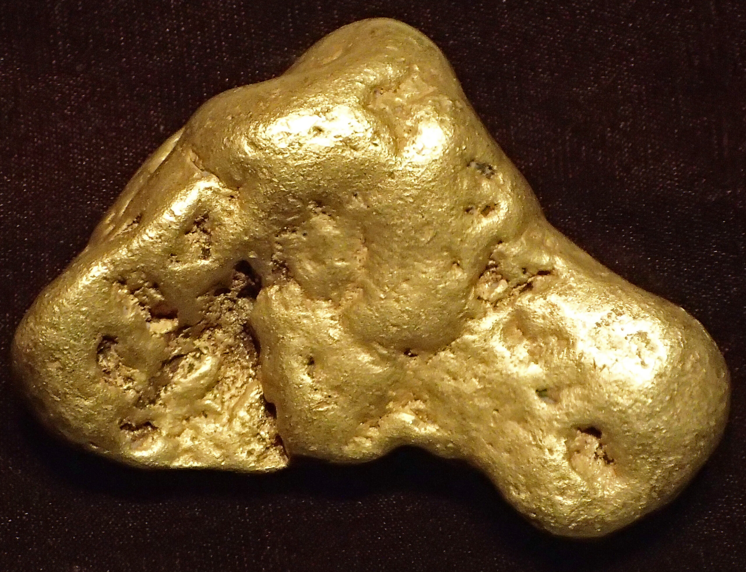 Bright yellow placer gold nugget from Pennsylvania Mountain, Colorado, an example of a mineral with very high specific gravity