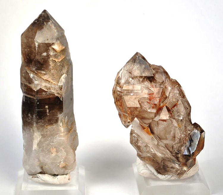 Cluster of colourless quartz crystals showing the classic six-sided prismatic habit ending in pointed pyramid terminations