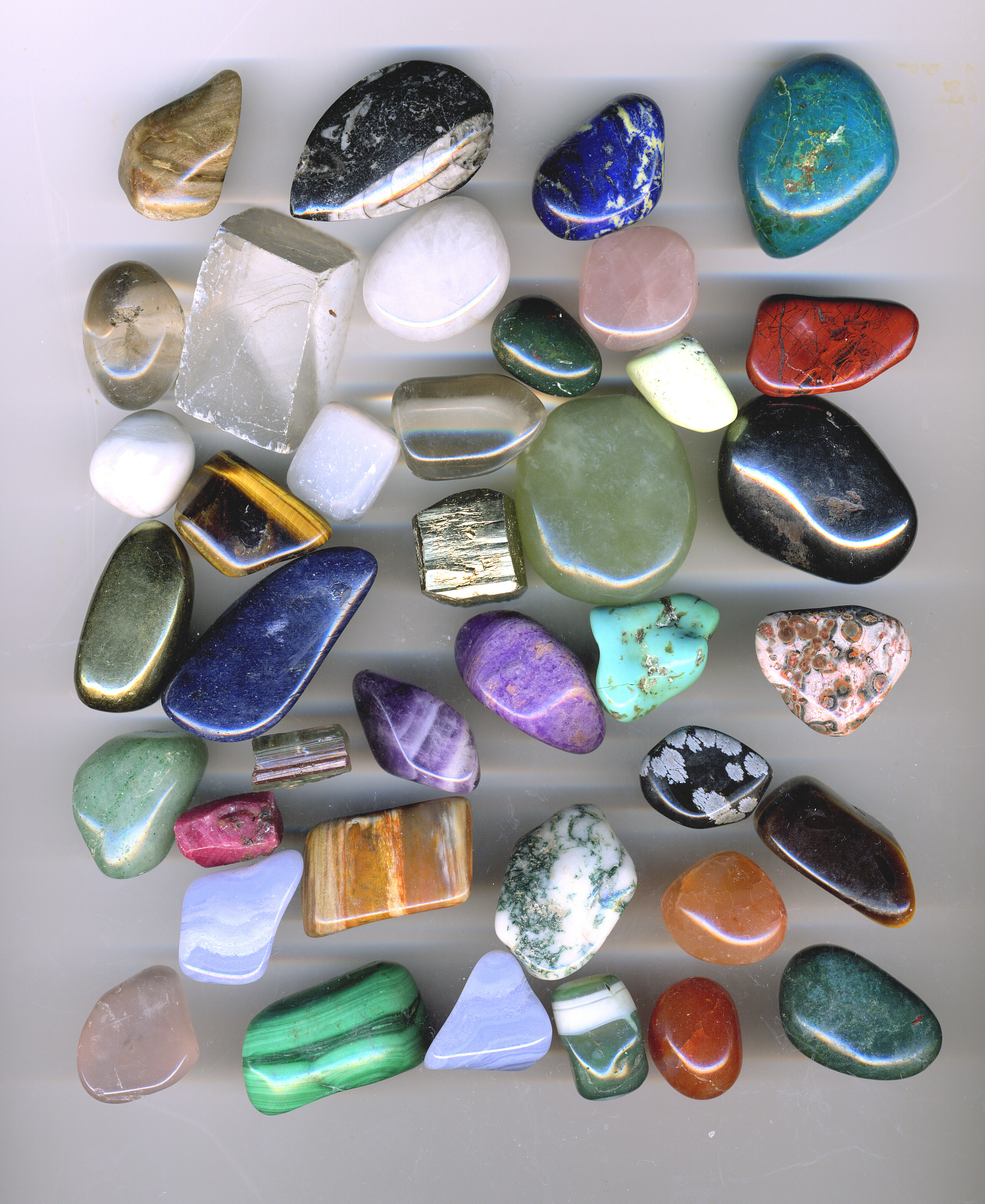Handful of colourful tumble-polished agate and jasper pebbles